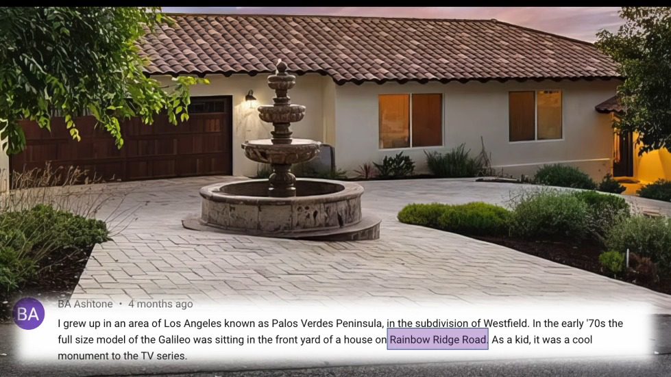 A fountain in front of a house Description automatically generated